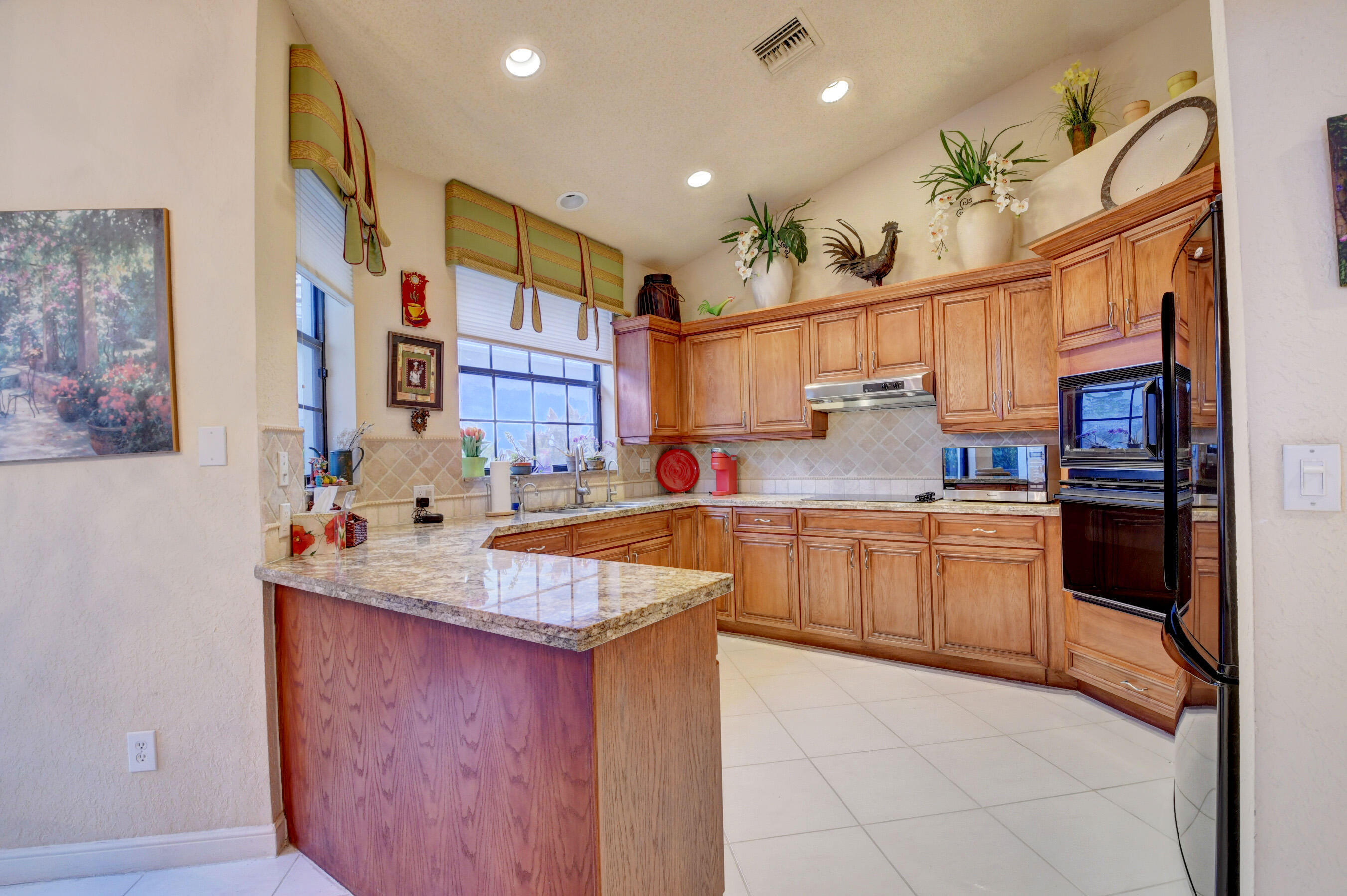 2187 Northwest 59th Street Boca Raton, FL 33496 - Photo 13 of 45 a kitchen with stainless steel appliances granite countertop a sink stove and cabinets