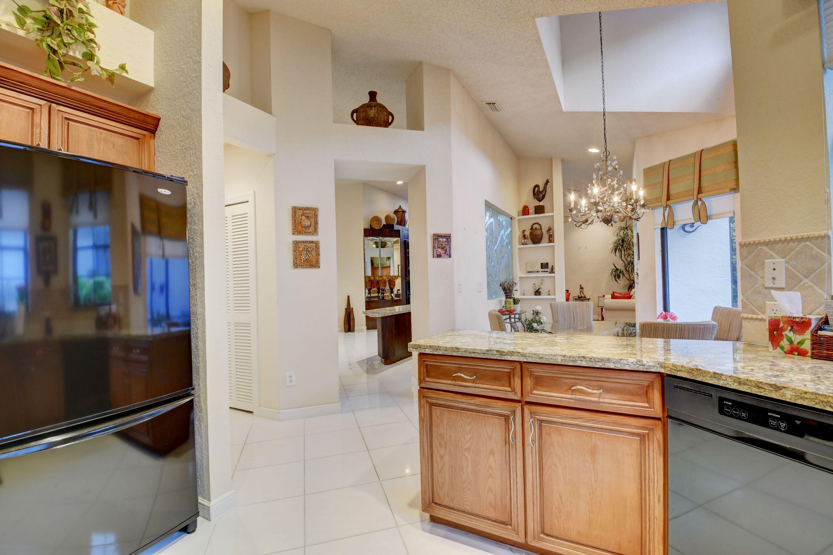 2187 Northwest 59th Street Boca Raton, FL 33496 - Photo 14 of 45 a kitchen with stainless steel appliances granite countertop a sink and cabinets