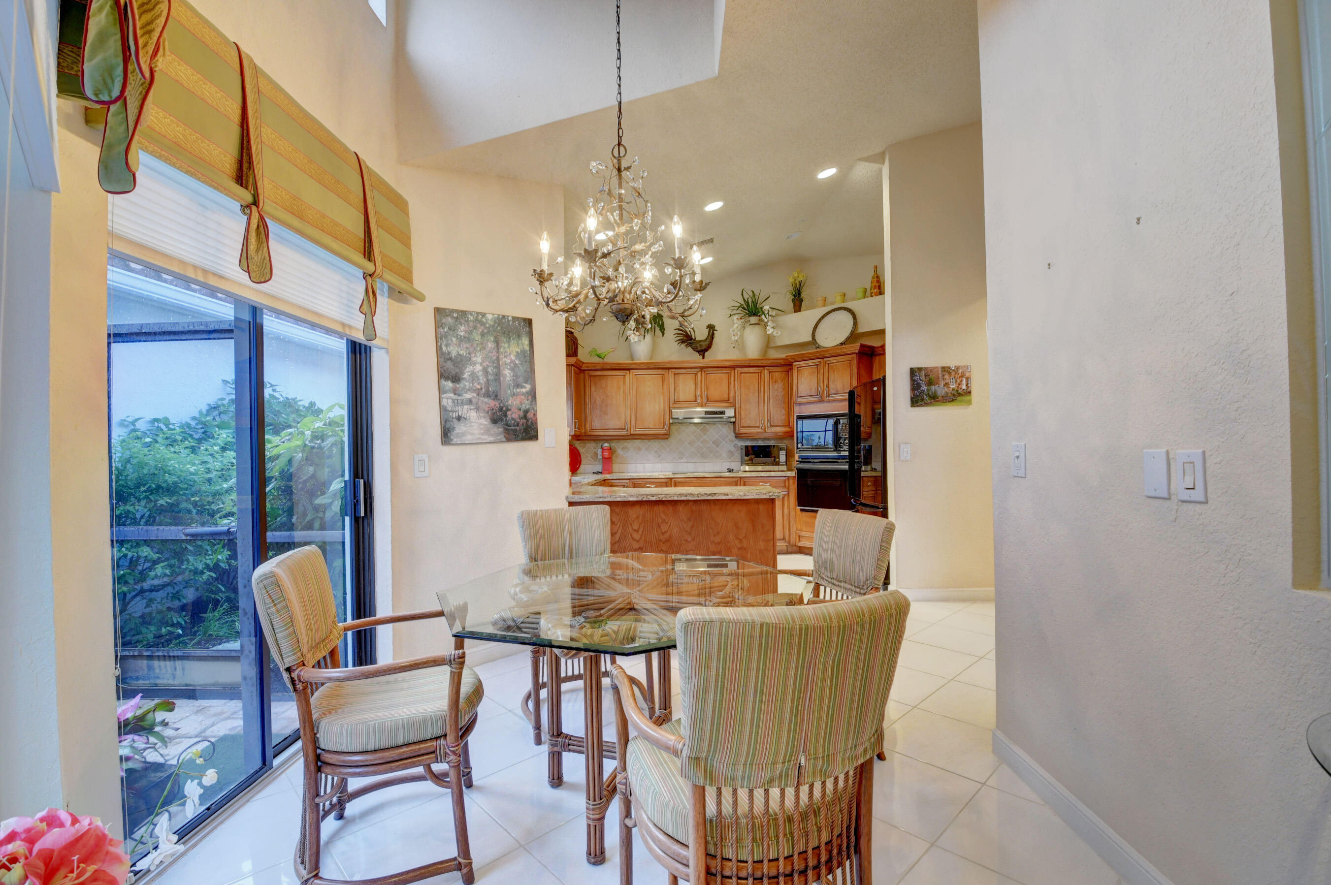 2187 Northwest 59th Street Boca Raton, FL 33496 - Photo 15 of 45 a dining room with furniture and chandelier kitchen view