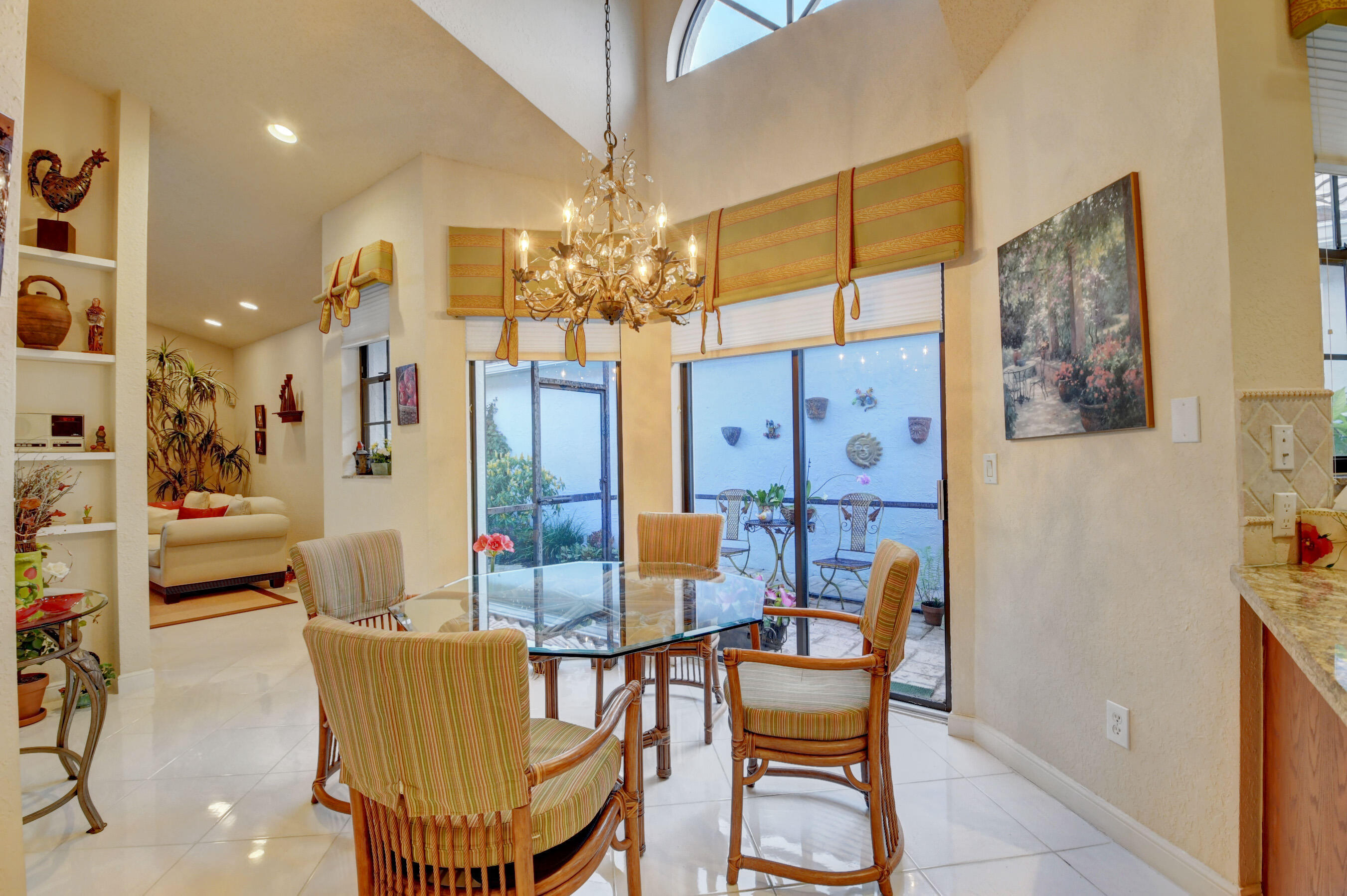 2187 Northwest 59th Street Boca Raton, FL 33496 - Photo 16 of 45 a view of a dining room with furniture and a chandelier