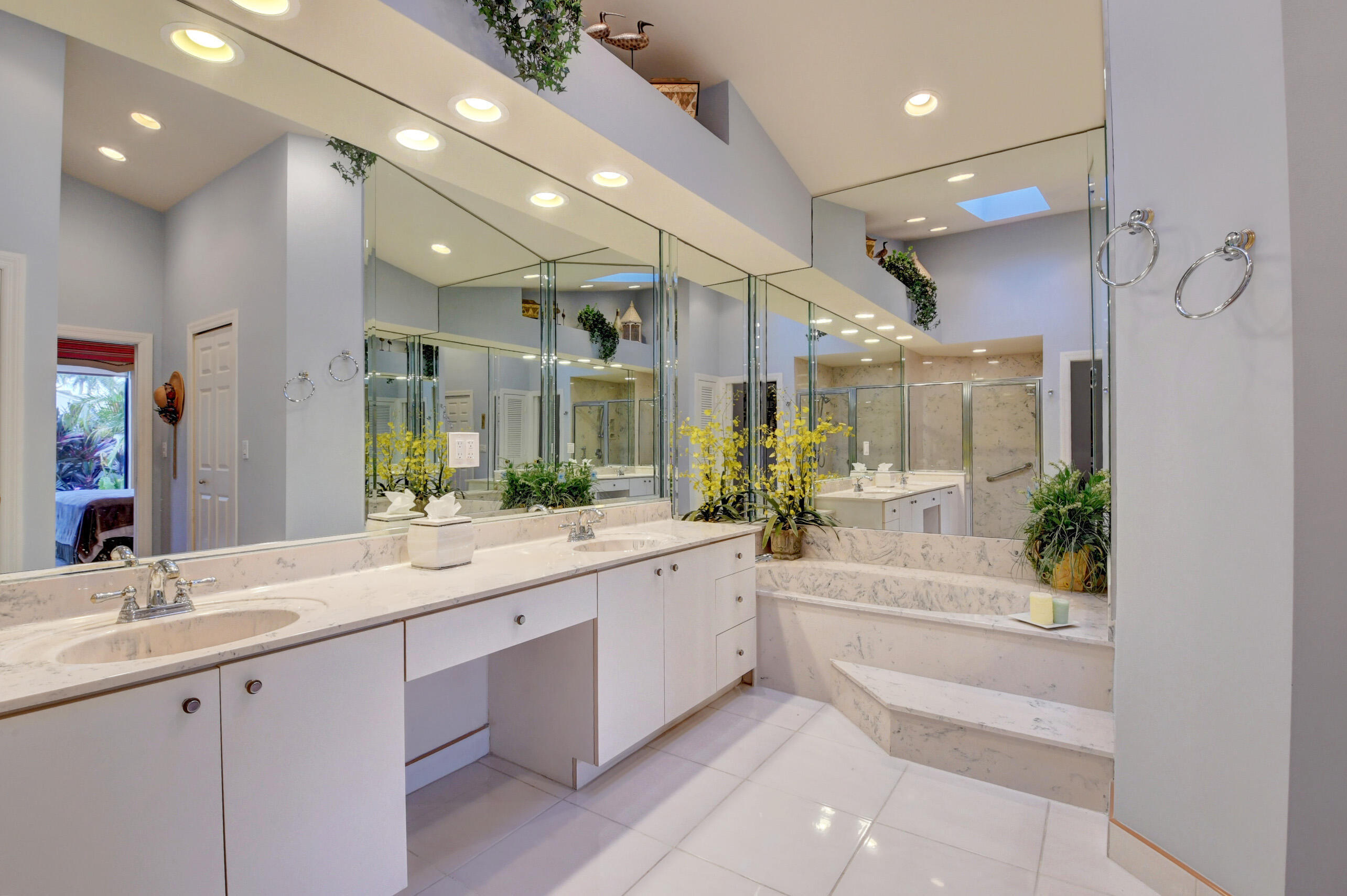 2187 Northwest 59th Street Boca Raton, FL 33496 - Photo 20 of 45 a spacious en suite bathroom with a granite countertop sink mirror and bathtub