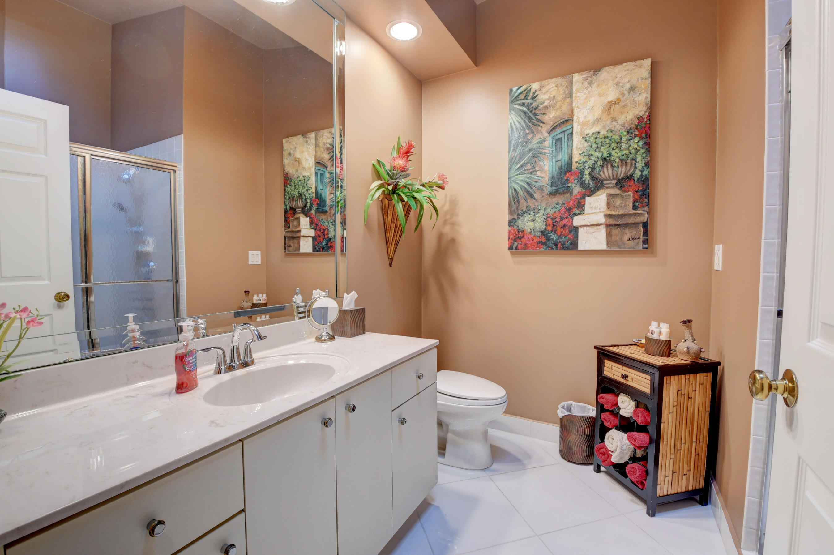 2187 Northwest 59th Street Boca Raton, FL 33496 - Photo 24 of 45 a bathroom with a toilet a sink and a large mirror