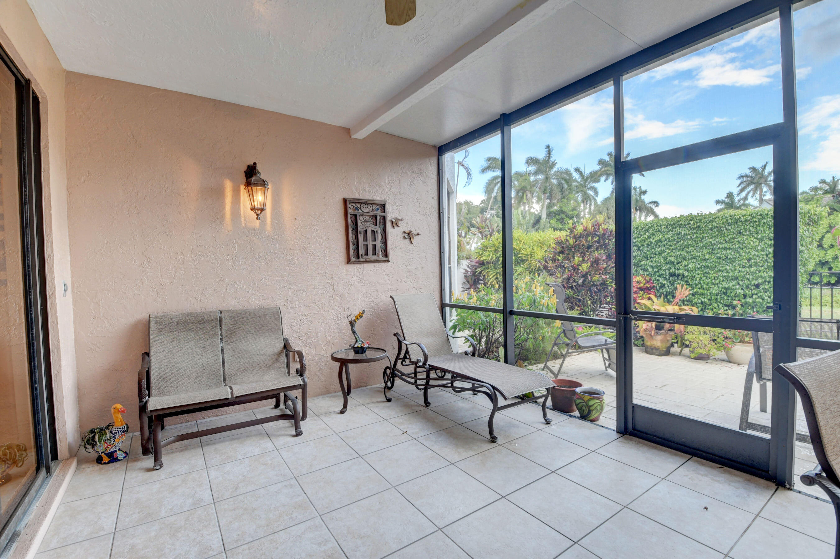2187 Northwest 59th Street Boca Raton, FL 33496 - Photo 29 of 45 a living room with furniture and a floor to ceiling window