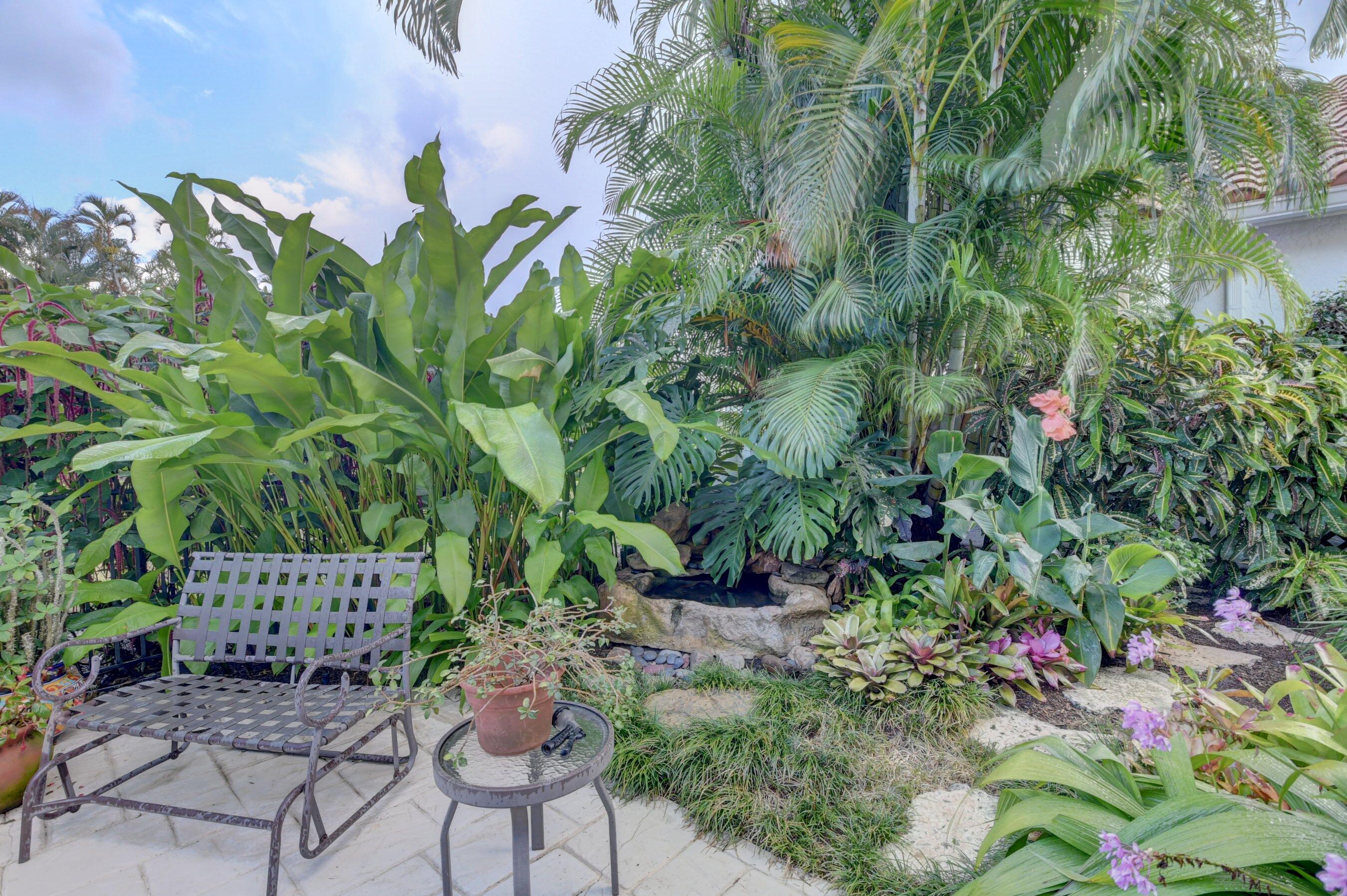 2187 Northwest 59th Street Boca Raton, FL 33496 - Photo 30 of 45 a backyard with plants and outdoor seating