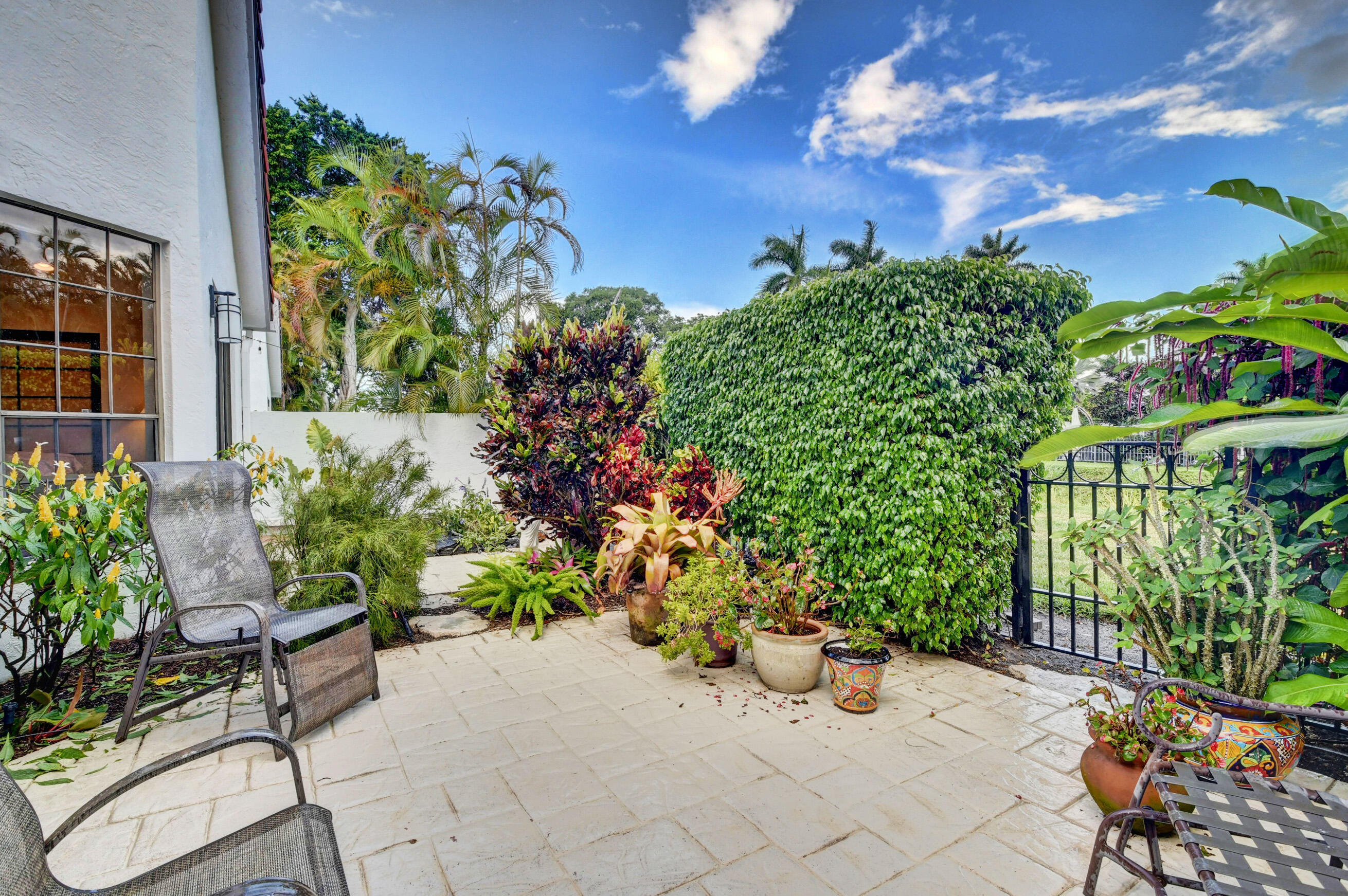2187 Northwest 59th Street Boca Raton, FL 33496 - Photo 31 of 45 a view of a chair and table in the garden