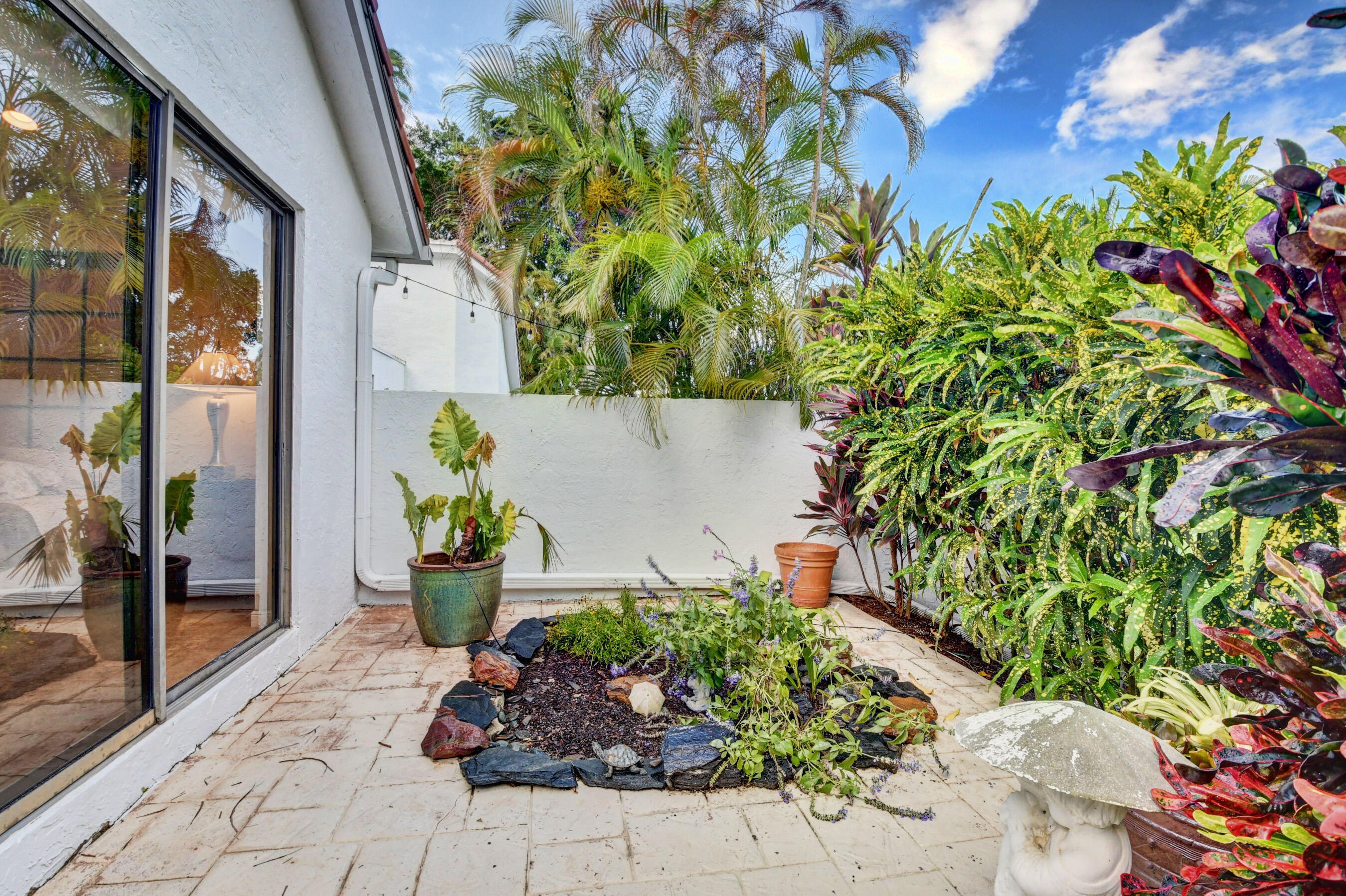2187 Northwest 59th Street Boca Raton, FL 33496 - Photo 32 of 45 a view of a garden with a potted plant