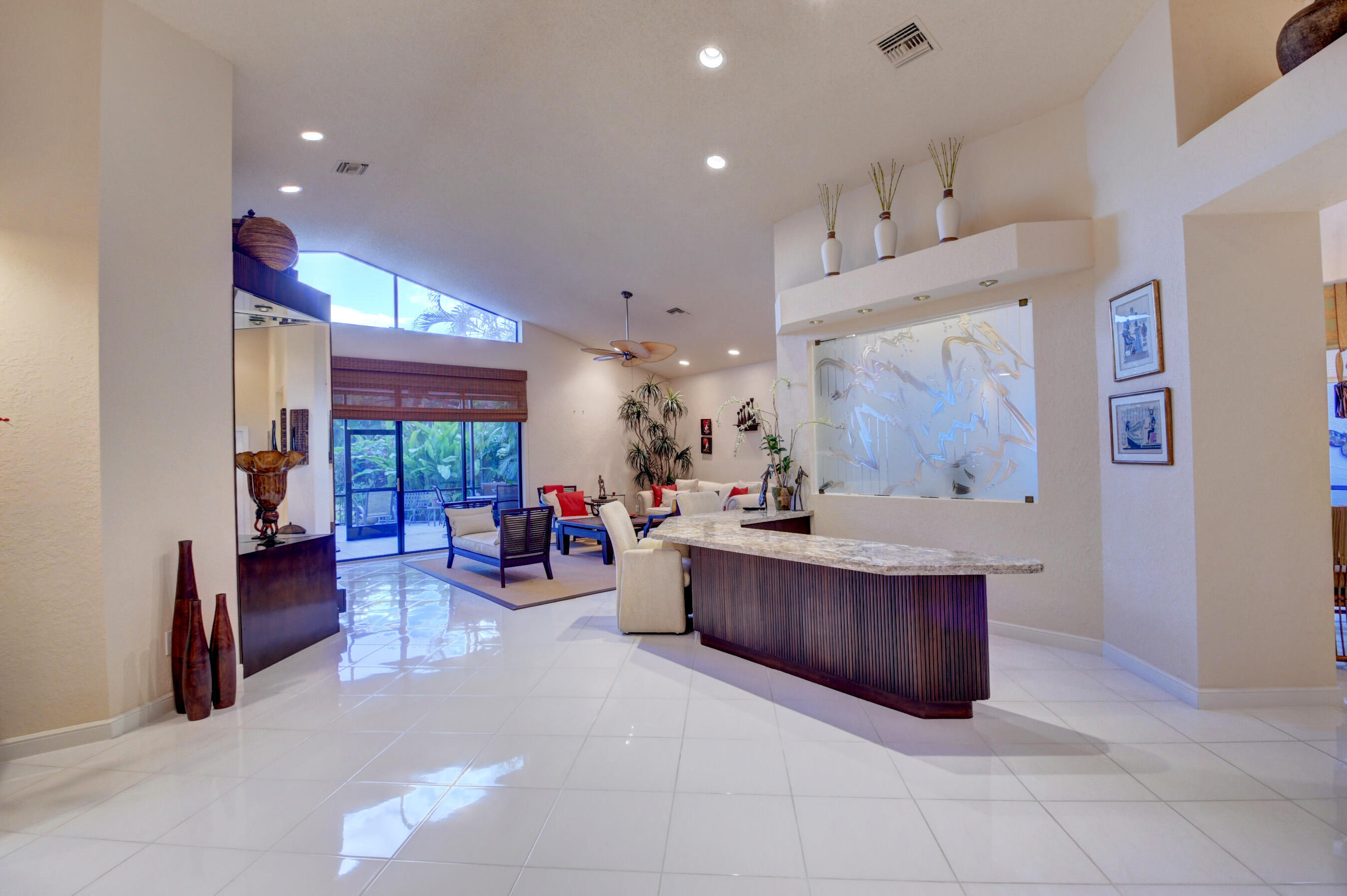 2187 Northwest 59th Street Boca Raton, FL 33496 - Photo 4 of 45 a living room with furniture and kitchen area
