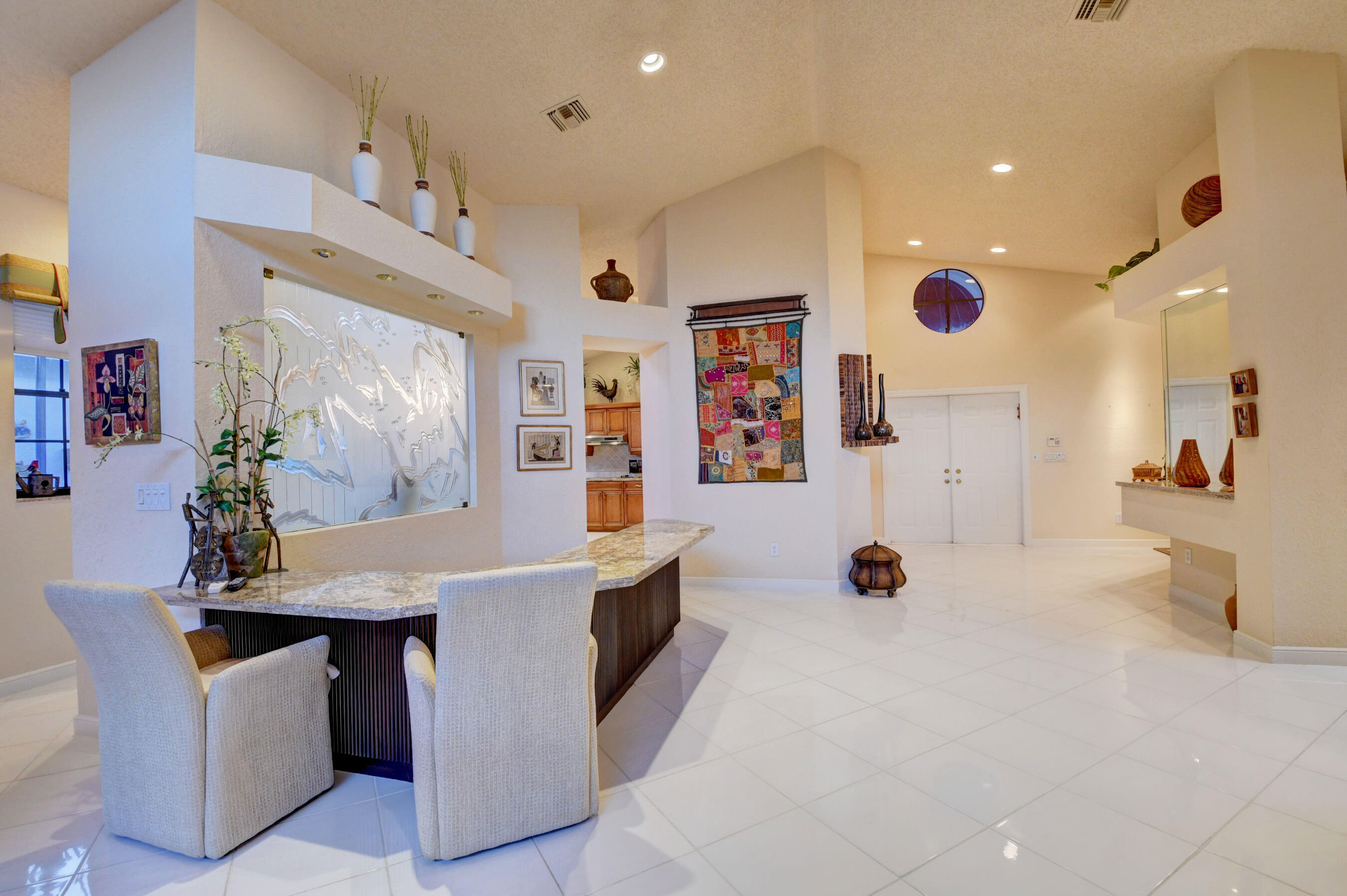 2187 Northwest 59th Street Boca Raton, FL 33496 - Photo 6 of 45 a view of kitchen with stainless steel appliances kitchen island granite countertop a table and chairs in it