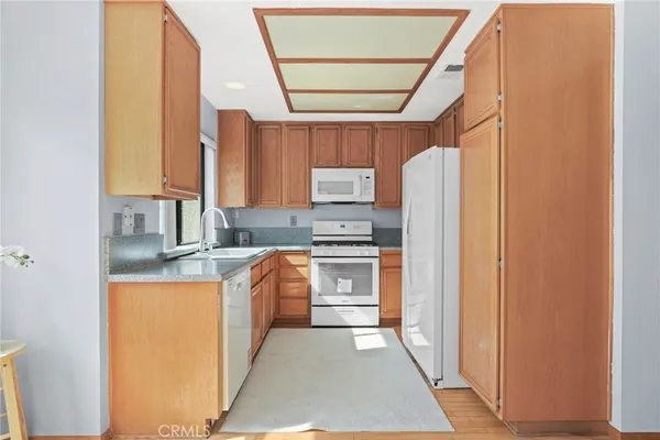 a kitchen with stainless steel appliances granite countertop a refrigerator and a stove