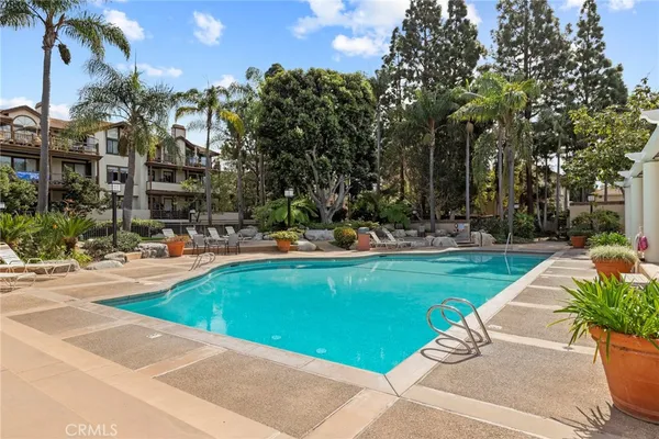 a view of a house with swimming pool and sitting area