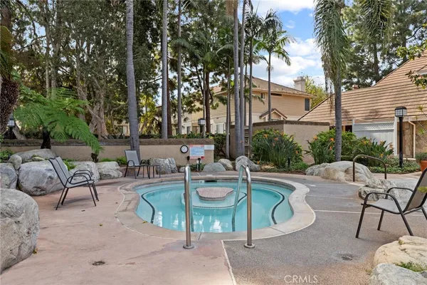 a view of a house with swimming pool and sitting area