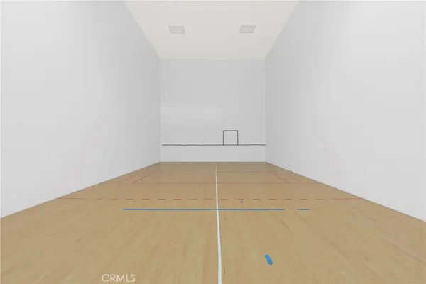 a room with a wooden floor and a window