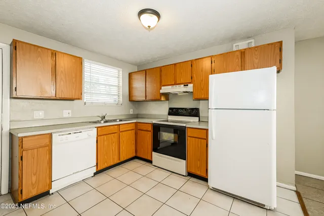 a kitchen with stainless steel appliances granite countertop a refrigerator sink and cabinets