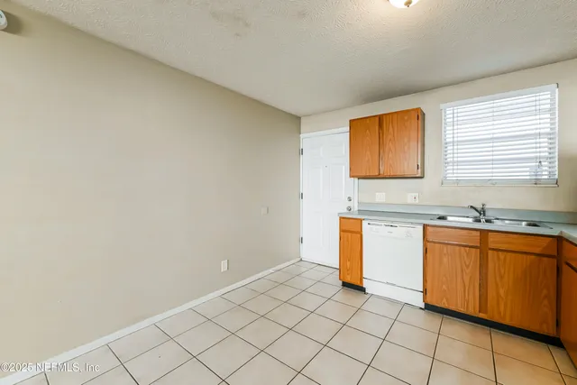 a kitchen with stainless steel appliances granite countertop a sink a cabinets and a window