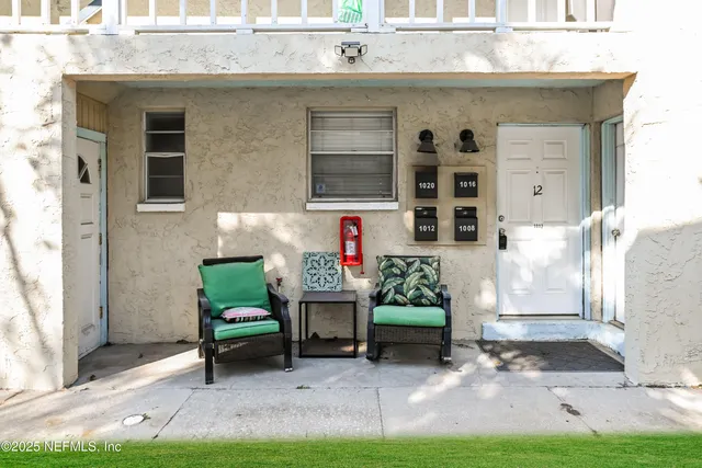 a front view of a house with outdoor seating and yard