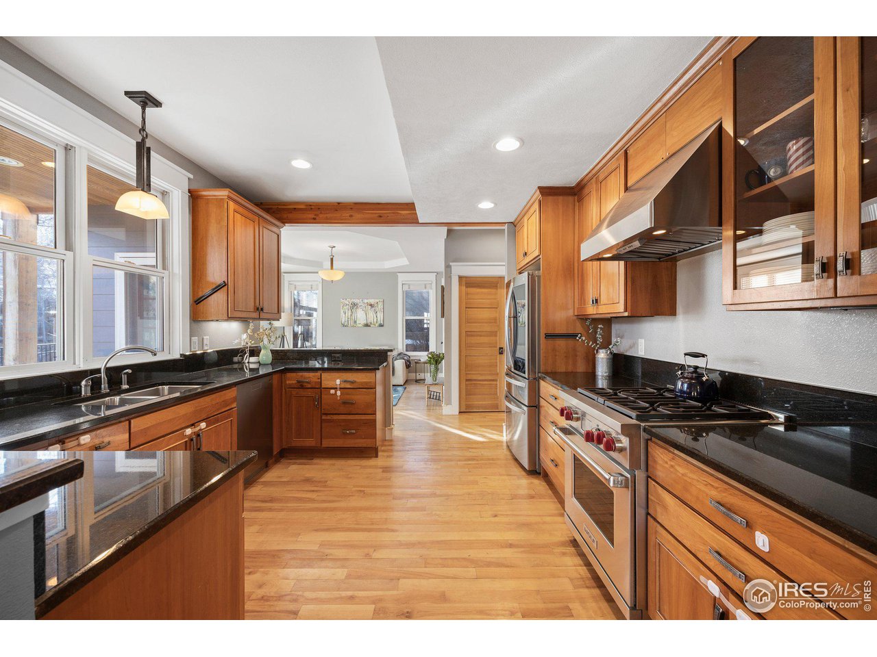1780 Baseline Road Boulder, CO 80302 - Photo 11 of 31 a large kitchen with stainless steel appliances a large counter top a stove a chimney a sink and cabinets