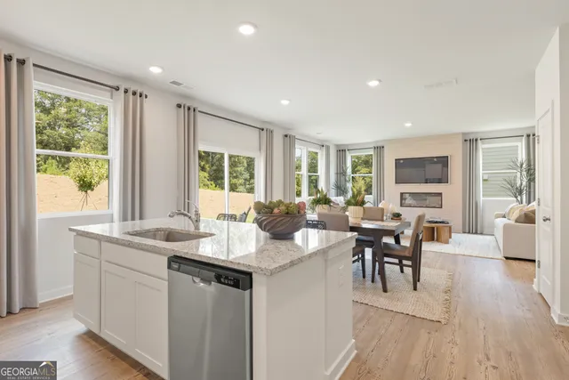 a kitchen with counter top space a sink cabinets and refrigerator