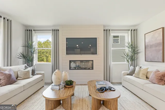 a kitchen with stainless steel appliances granite countertop a stove top oven a sink a refrigerator white cabinets and wooden floor