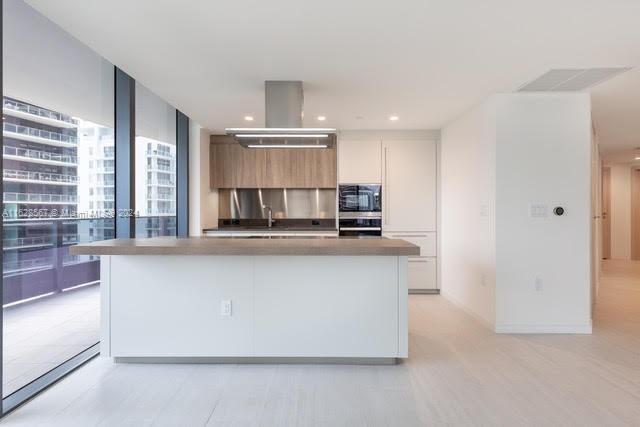 1000 Brickell Plaza, Unit 4015 Miami, FL 33131 - Photo 1 of 29 a living room with stainless steel appliances kitchen island granite countertop a refrigerator a stove and a sink with wooden floor