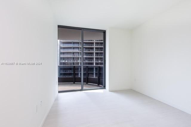 1000 Brickell Plaza, Unit 4015 Miami, FL 33131 - Photo 12 of 29 a view of an empty room with a fireplace and a window