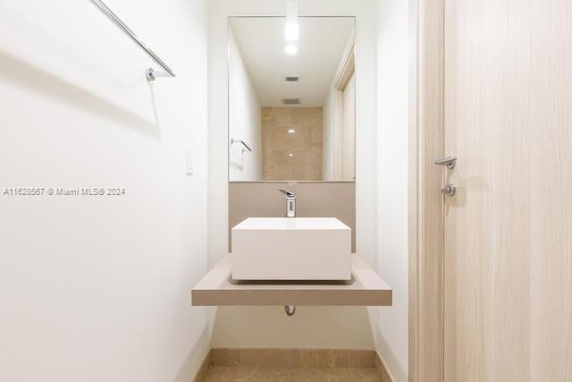 1000 Brickell Plaza, Unit 4015 Miami, FL 33131 - Photo 15 of 29 a bathroom with a sink a mirror and shower