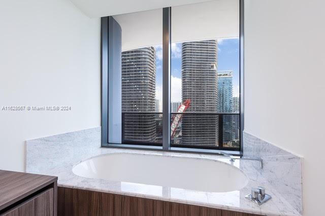 1000 Brickell Plaza, Unit 4015 Miami, FL 33131 - Photo 23 of 29 a bathroom with a bathtub and window