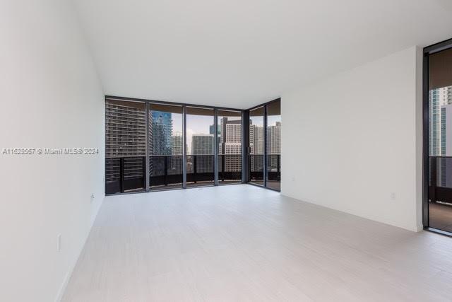 1000 Brickell Plaza, Unit 4015 Miami, FL 33131 - Photo 5 of 29 wooden floor in an empty room with a window