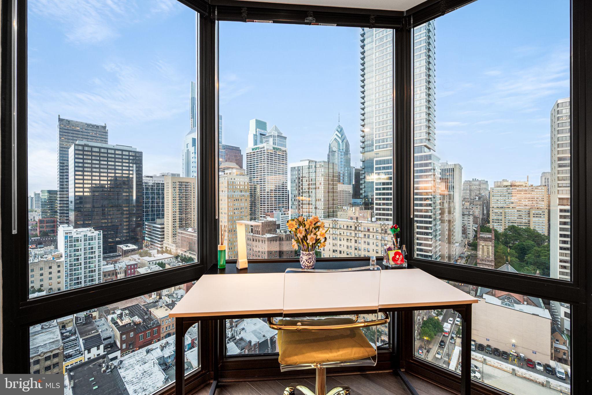 2020 Walnut Street, Unit 25B Philadelphia, PA 19103 - Photo 11 of 42 a view of a city from a dining room with large windows and furniture