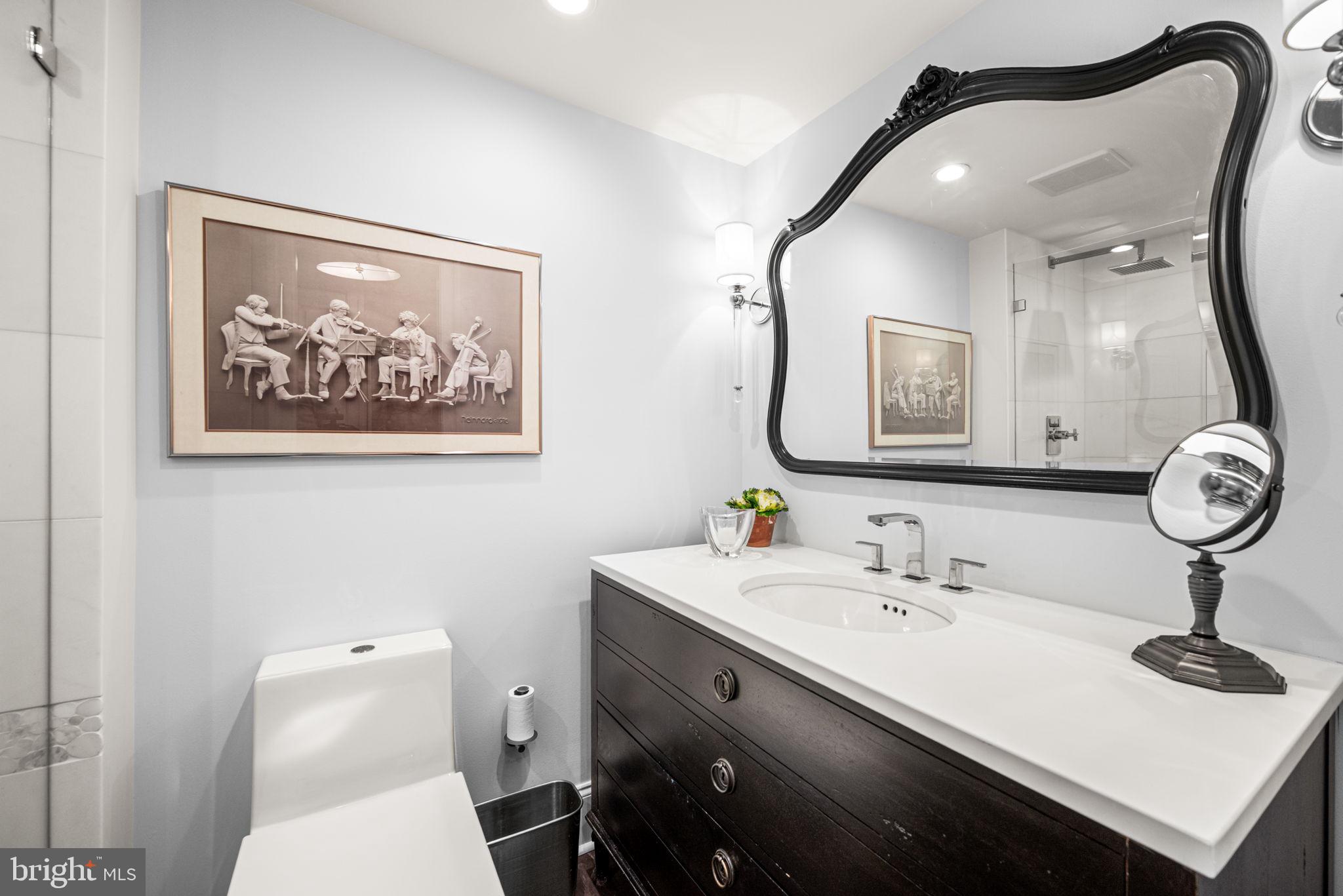 2020 Walnut Street, Unit 25B Philadelphia, PA 19103 - Photo 22 of 42 a bathroom with a sink mirror and toilet