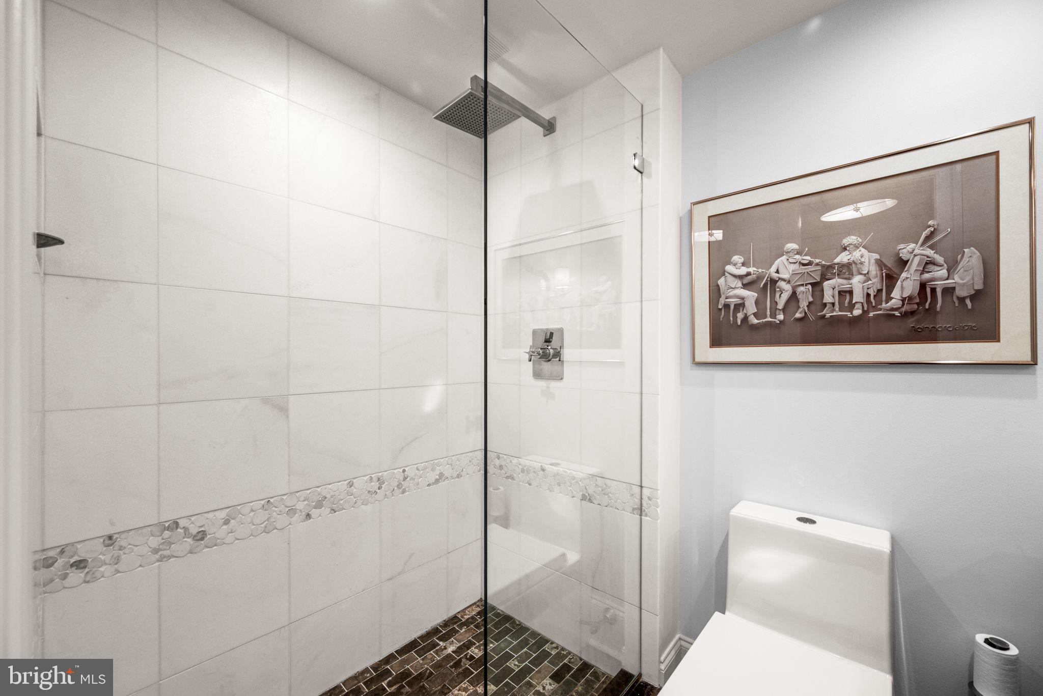 2020 Walnut Street, Unit 25B Philadelphia, PA 19103 - Photo 23 of 42 a bathroom with a shower and a toilet