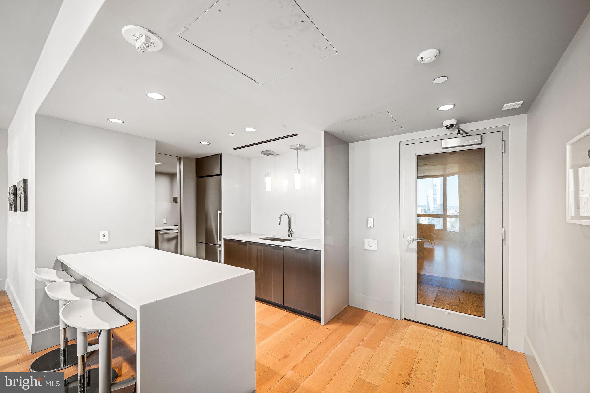 2020 Walnut Street, Unit 25B Philadelphia, PA 19103 - Photo 34 of 42 a kitchen with kitchen island a sink stainless steel appliances and cabinets