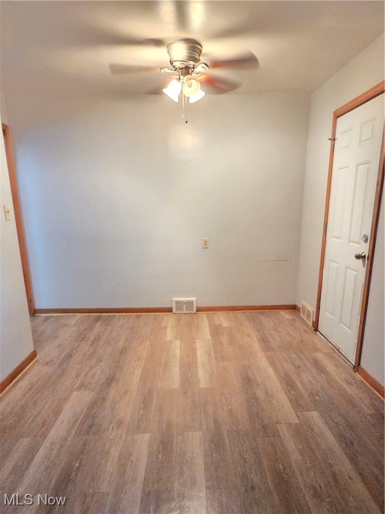 14712 Rockside Road Maple Heights, OH 44137 - Photo 6 of 23 Empty room with wood finished floors and ceiling fan