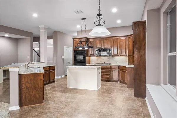 a kitchen with a center island and cabinets