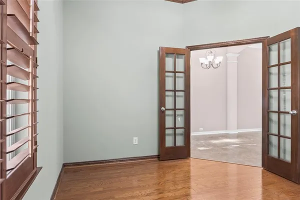 a view of an empty room with wooden floor