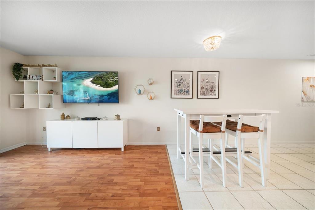 1500 Gulf Boulevard, Unit 103B Indian Rocks Beach, FL 33785 - Photo 13 of 58 a living room with furniture and flat screen tv