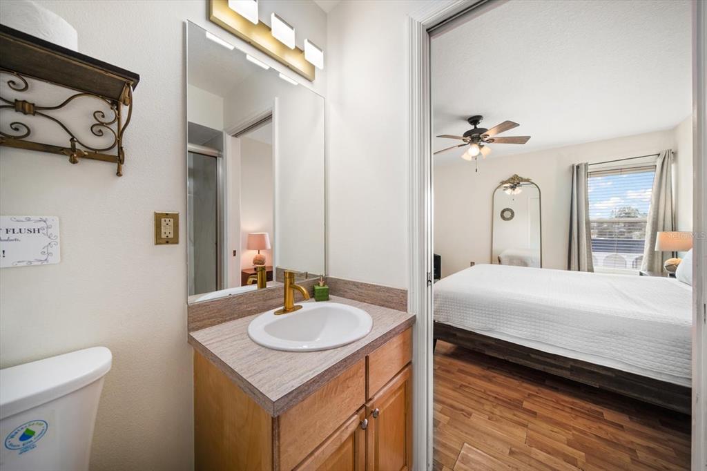 1500 Gulf Boulevard, Unit 103B Indian Rocks Beach, FL 33785 - Photo 18 of 58 a bedroom with a bed and a bathroom