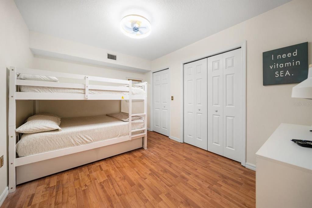 1500 Gulf Boulevard, Unit 103B Indian Rocks Beach, FL 33785 - Photo 20 of 58 a bedroom with a bed and a table