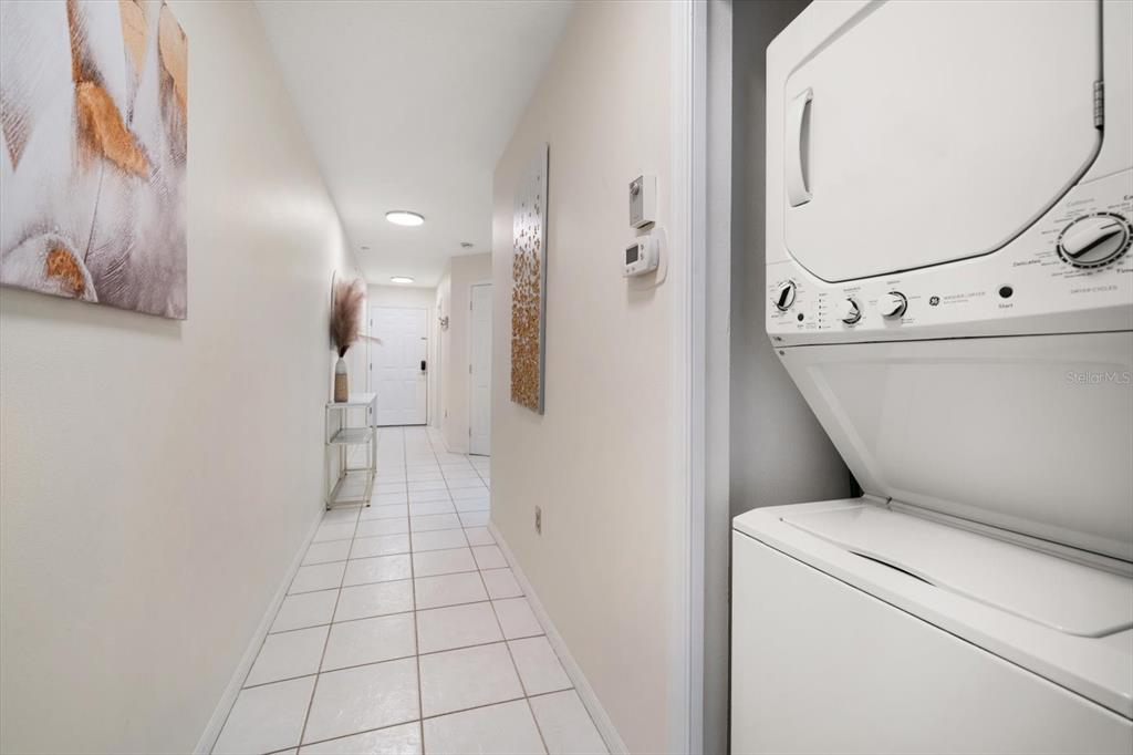 1500 Gulf Boulevard, Unit 103B Indian Rocks Beach, FL 33785 - Photo 26 of 58 a view of washer and dryer with bathroom in the background