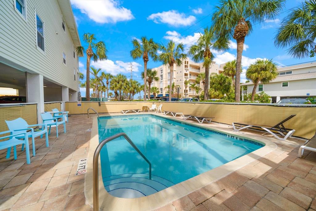 1500 Gulf Boulevard, Unit 103B Indian Rocks Beach, FL 33785 - Photo 34 of 58 a view of a swimming pool with an outdoor seating