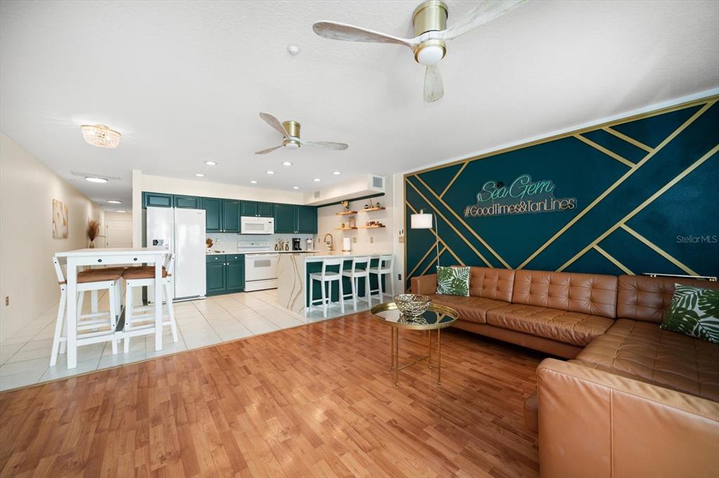 1500 Gulf Boulevard, Unit 103B Indian Rocks Beach, FL 33785 - Photo 5 of 58 a open kitchen with white cabinets a table and chairs