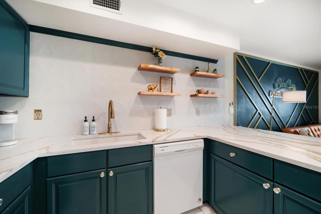 1500 Gulf Boulevard, Unit 103B Indian Rocks Beach, FL 33785 - Photo 7 of 58 a kitchen with a sink and cabinets