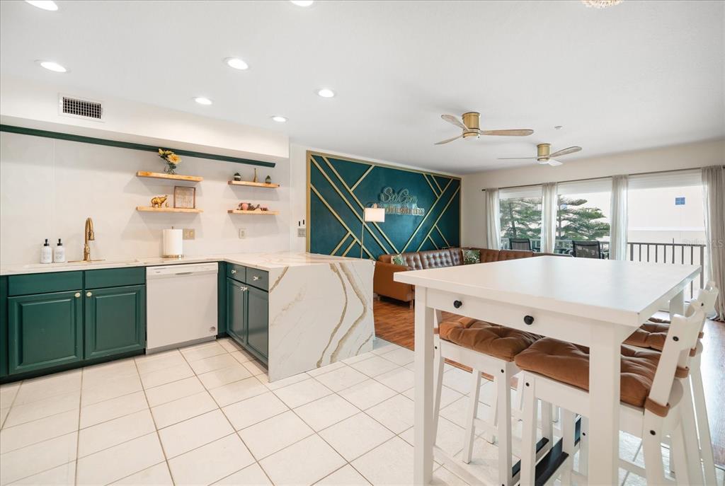 1500 Gulf Boulevard, Unit 103B Indian Rocks Beach, FL 33785 - Photo 8 of 58 a kitchen with a sink appliances and cabinets