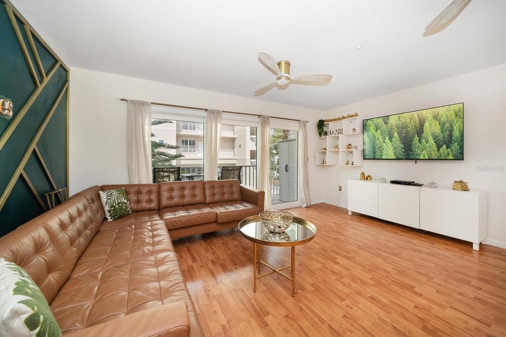 1500 Gulf Boulevard, Unit 103B Indian Rocks Beach, FL 33785 - Photo 9 of 58 a living room with furniture and a flat screen tv