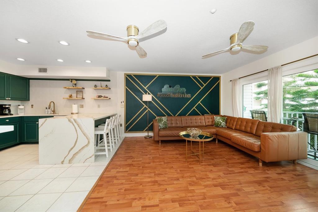 1500 Gulf Boulevard, Unit 103B Indian Rocks Beach, FL 33785 - Photo 10 of 58 a living room with furniture a air conditioner and a large window