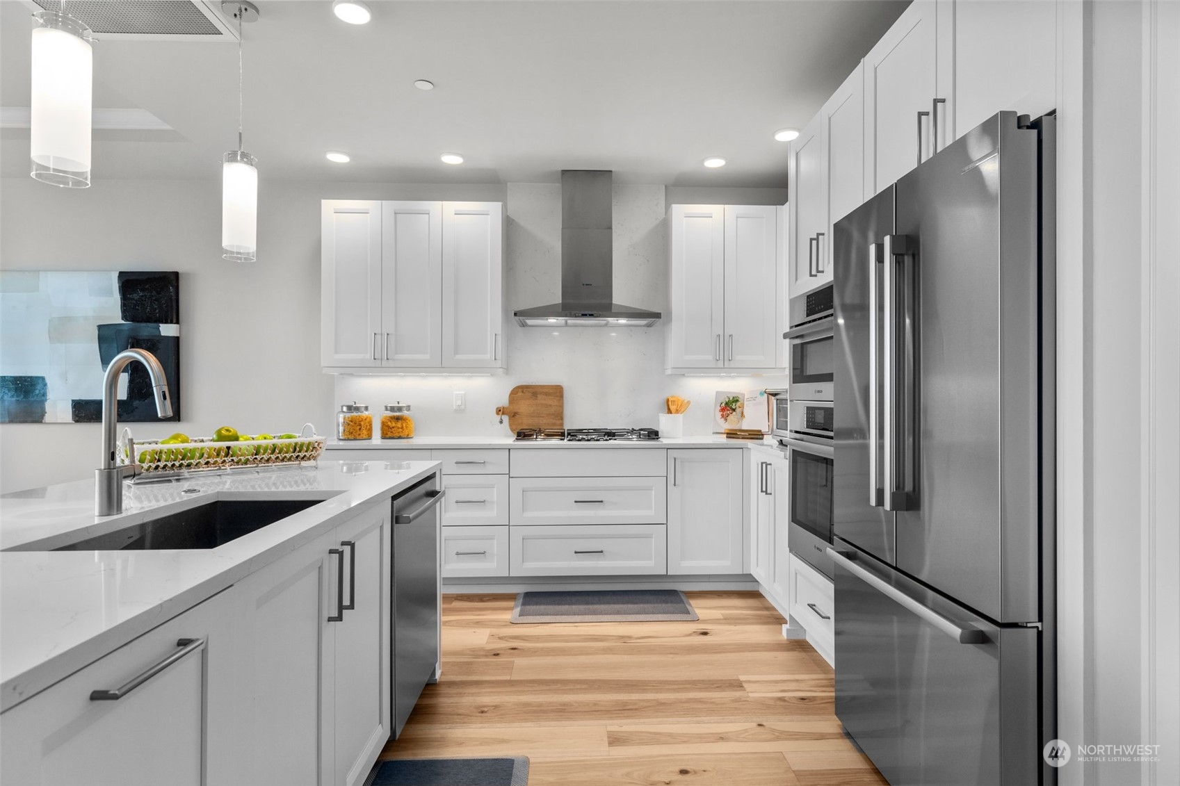 4907 Main Street, Unit 508 Tacoma, WA 98407 - Photo 5 of 40 a kitchen with white cabinets and stainless steel appliances