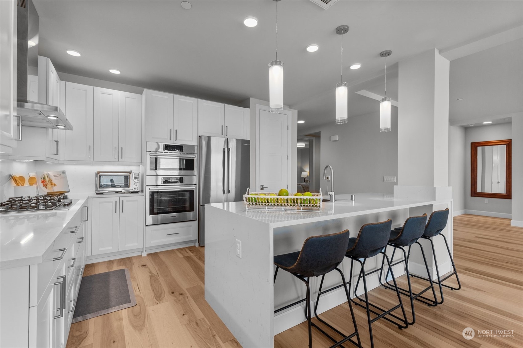 4907 Main Street, Unit 508 Tacoma, WA 98407 - Photo 10 of 40 a kitchen with stainless steel appliances a dining table chairs stove refrigerator and cabinets