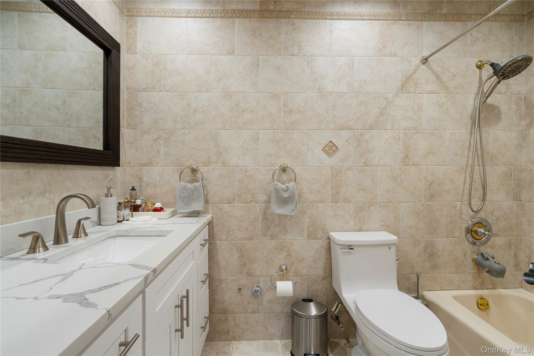 208-48 15th Road, Unit 2 Queens, NY 11360 - Photo 13 of 23 Full bathroom with vanity, tile walls, and shower combination