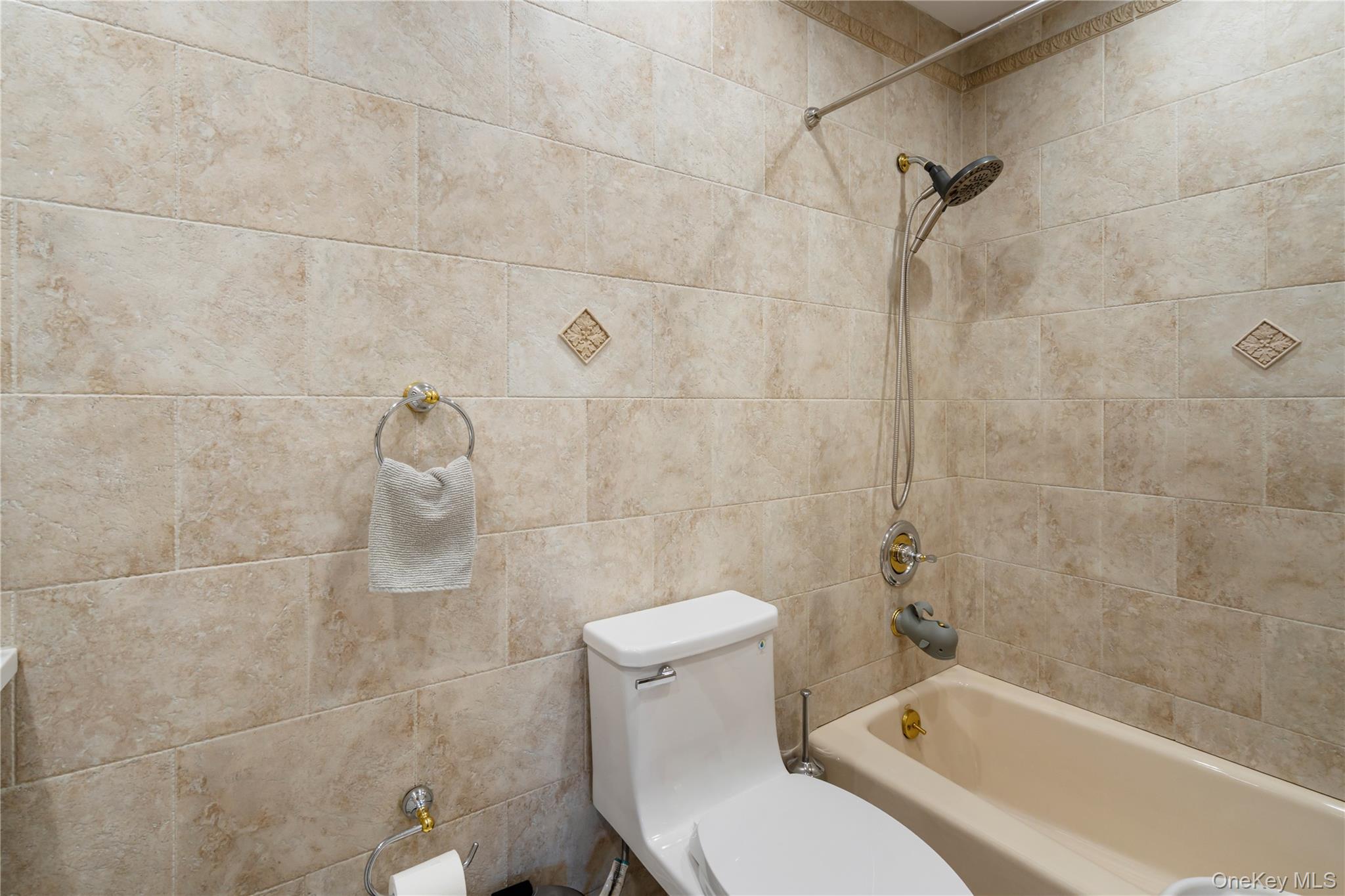 208-48 15th Road, Unit 2 Queens, NY 11360 - Photo 14 of 23 Full bath featuring tub / shower combination and toilet