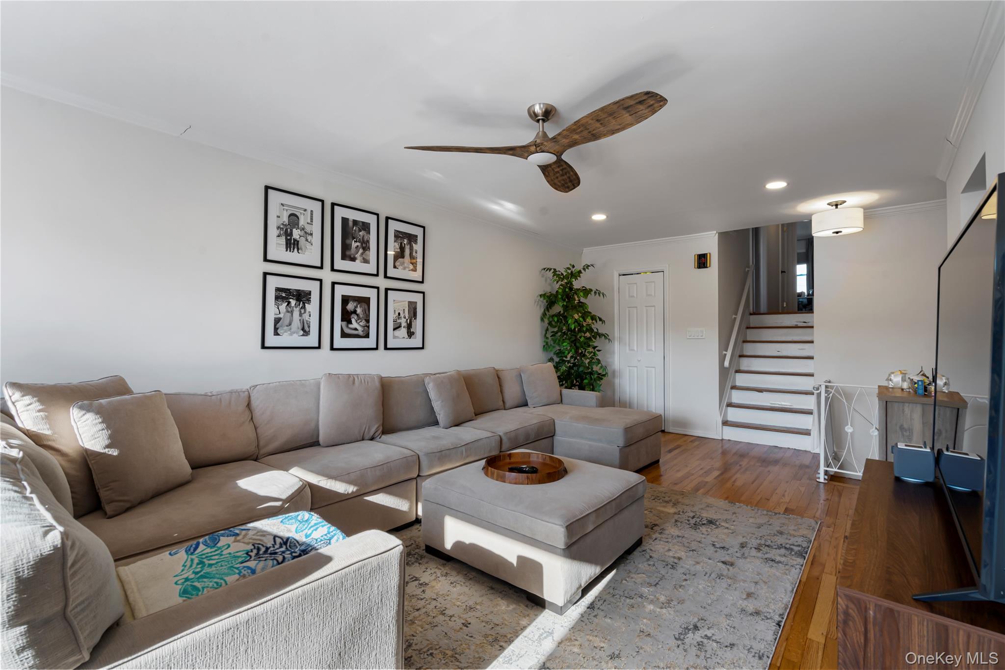208-48 15th Road, Unit 2 Queens, NY 11360 - Photo 5 of 23 Living room featuring ornamental molding, stairway, hardwood / wood-style flooring, recessed lighting, and ceiling fan
