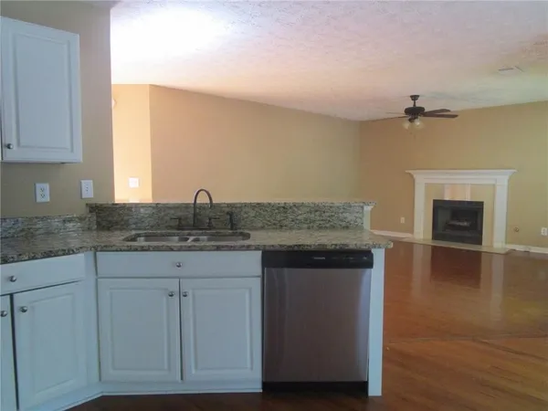 a kitchen with sink and cabinets